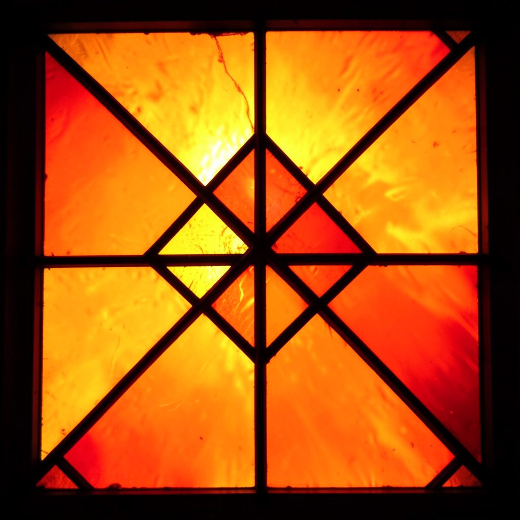 Geometric event graphic with overlapping translucent rectangles in burnt orange and cream.